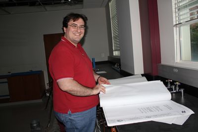 Dr. Bonizzoni pores over the plans for the renovation of the space in Shelby Hall that will become his labs.
